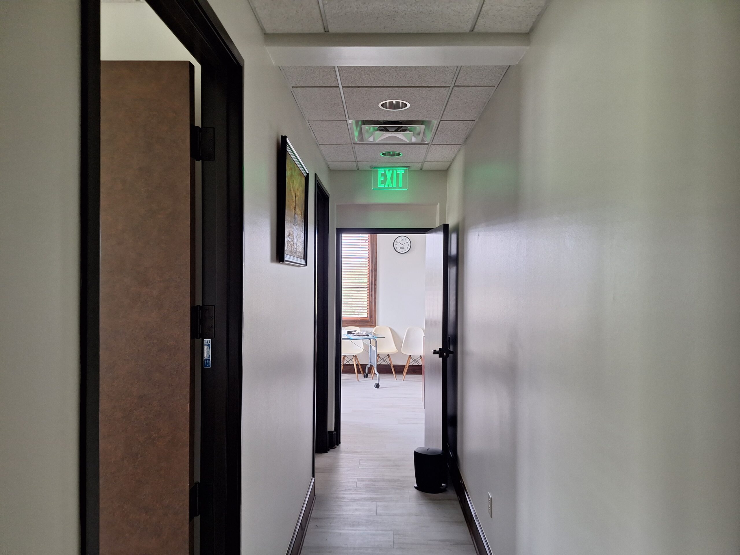 Commercial Office hallway that is missing life safety equipment, after a newly framed drywall in an Austin, Texas office remodel.