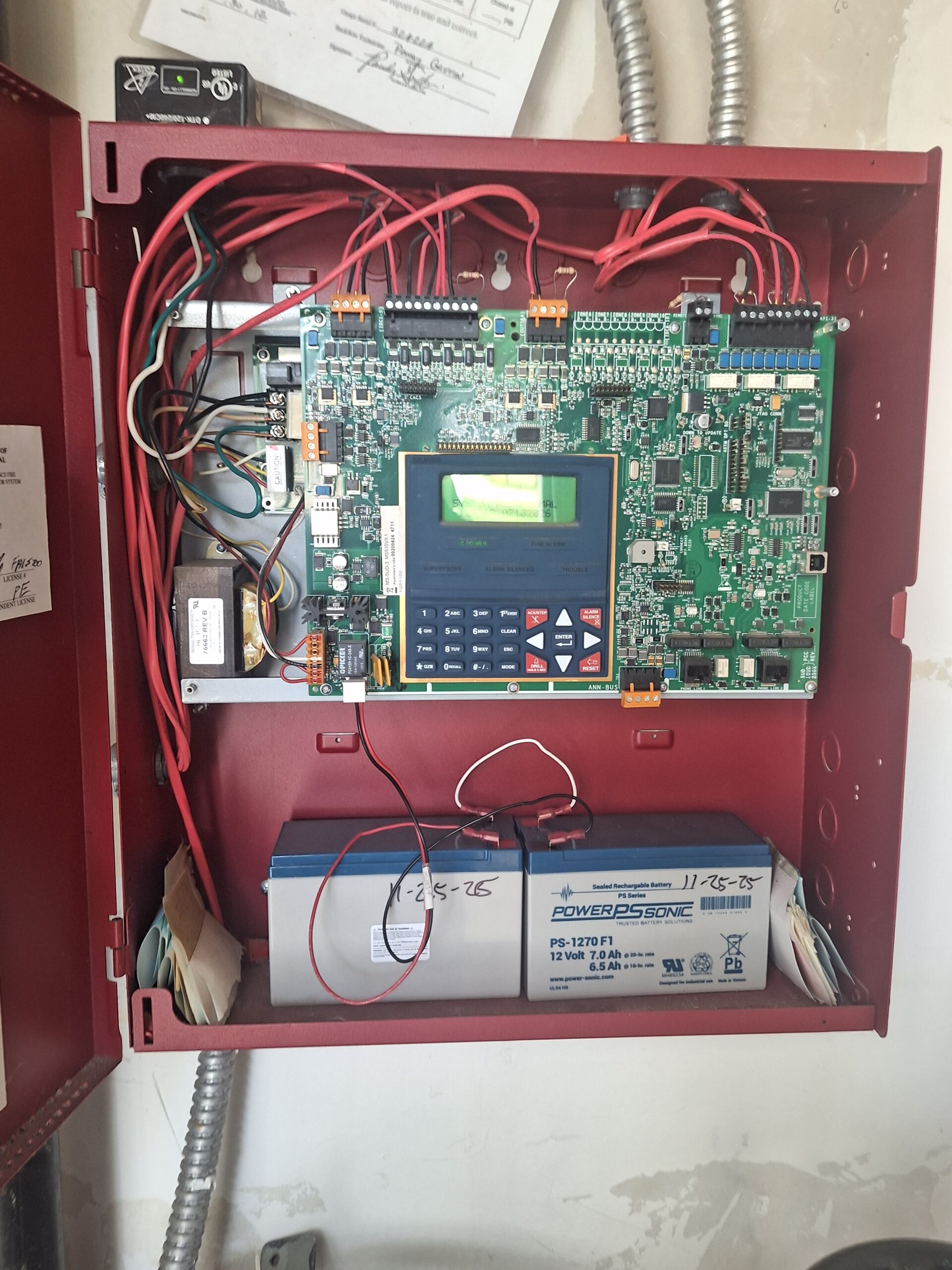 A fire panel in need of repairs requiring an active fire watch log for a commercial building in Austin, Texas.